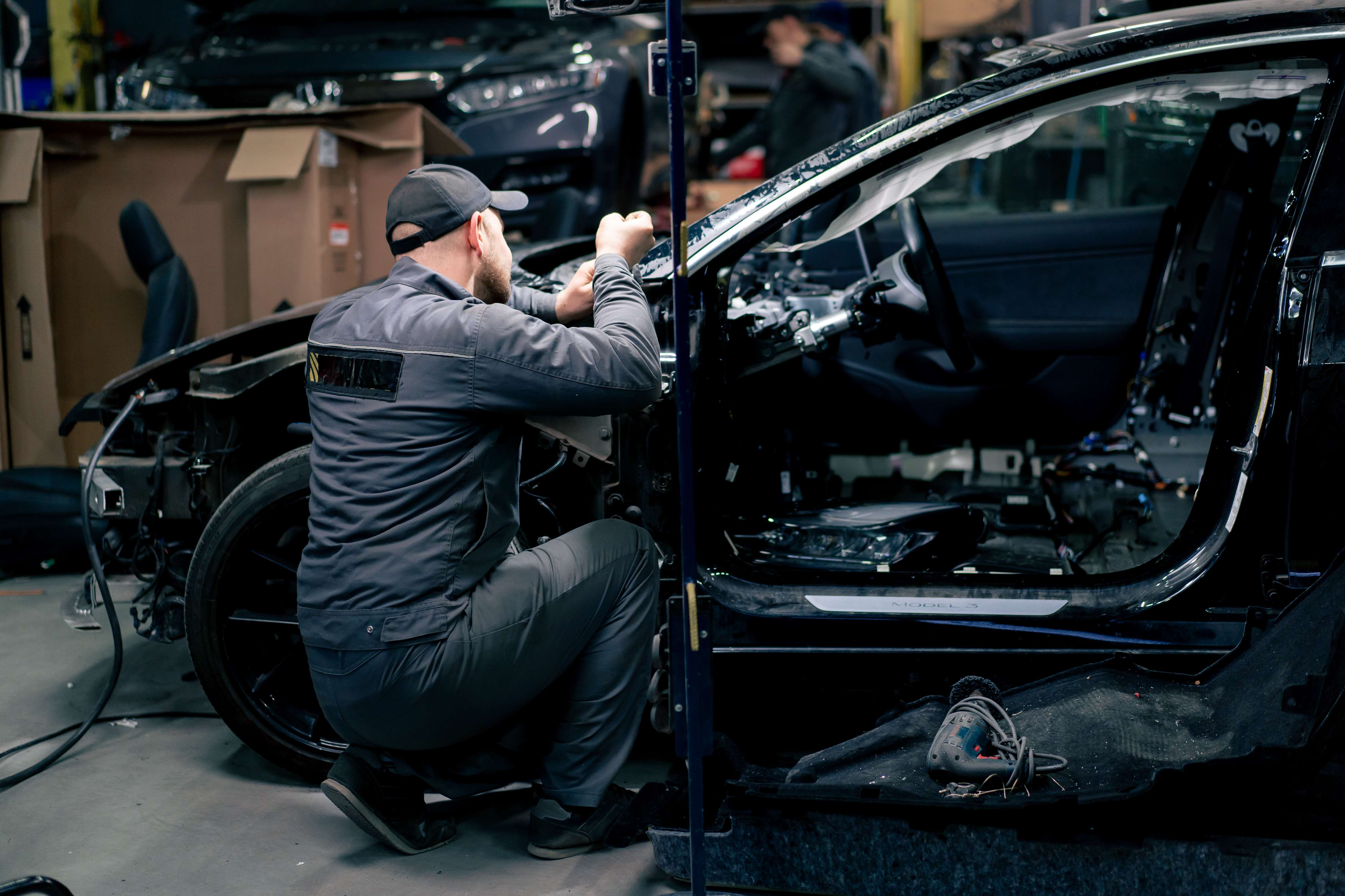 Mechanic repairing a car at EZ Automotive